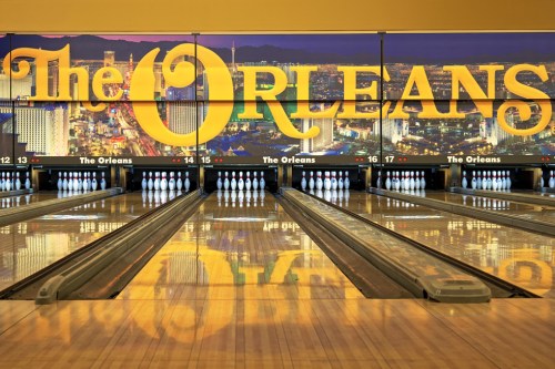 Bowling alley at The Orleans, featuring lanes and a large illuminated sign in the background.