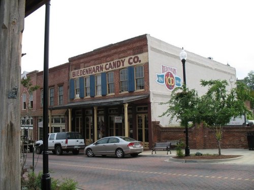 Historic Biedenharn Candy Co. building with brick facade and signage, located on a quaint street.