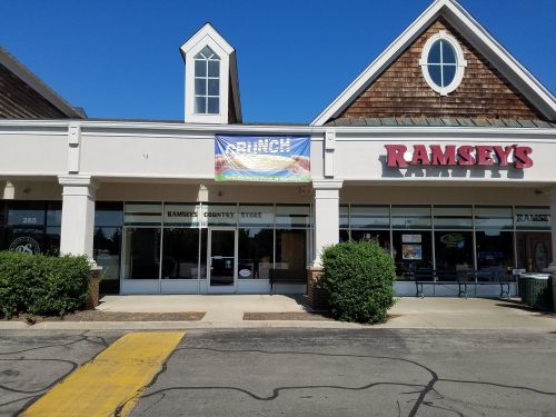 Exterior of Ramsey's Country Store with a "Brunch" banner and clear blue sky above.