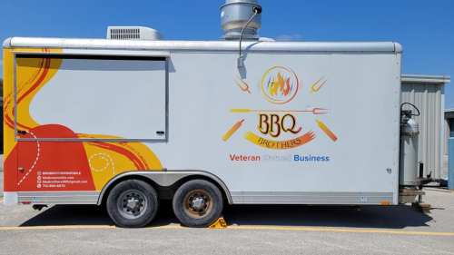 A food truck with a colorful design, featuring the name "BBQ Brothers" and "Veteran Owned Business" on the side.