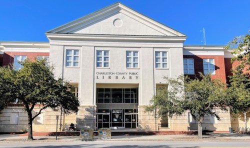 Front view of the Charleston County Public Library, featuring a modern architectural design and surrounding trees.