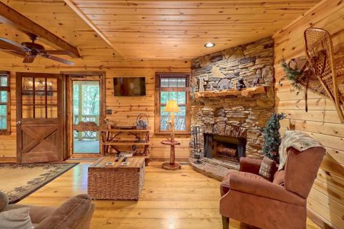 Cozy cabin interior with wooden walls, a stone fireplace, comfortable seating, and a warm, inviting atmosphere.
