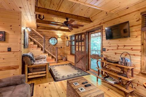 Cozy wooden cabin interior with a living area, staircase, and large windows, featuring rustic decor and warm lighting.