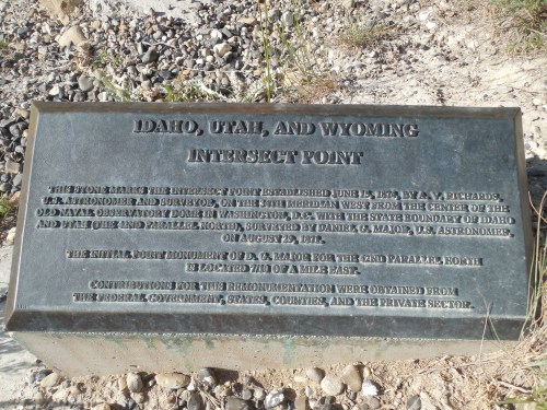 Plaque marking the Idaho, Utah, and Wyoming intersect point, established in 1878, detailing survey information.