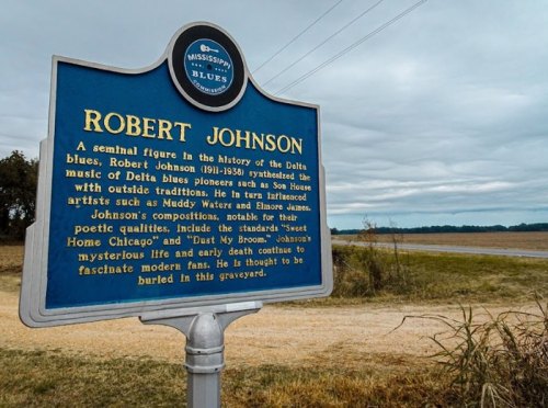 Historical marker about Robert Johnson, a key figure in Delta blues music, highlighting his influence and legacy.