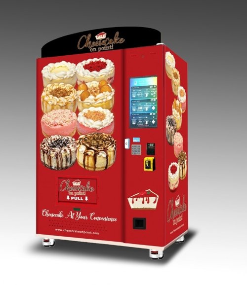 A bright red vending machine featuring various cheesecake desserts and a touchscreen for ordering.