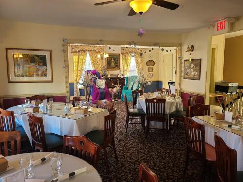 Cozy restaurant interior with tables set for dining, colorful decor, and a welcoming atmosphere.