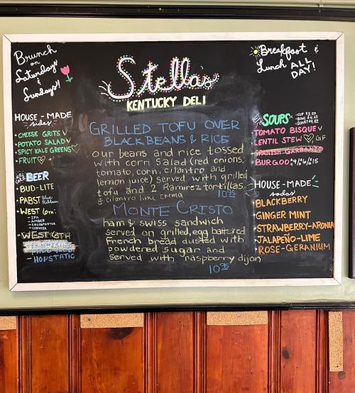 Chalkboard menu at Stella's Kentucky Deli featuring brunch items, including grilled tofu, Monte Cristo, and drinks.