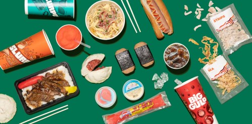 A colorful spread of various fast foods, including drinks, noodles, hot dogs, and snacks on a green background.