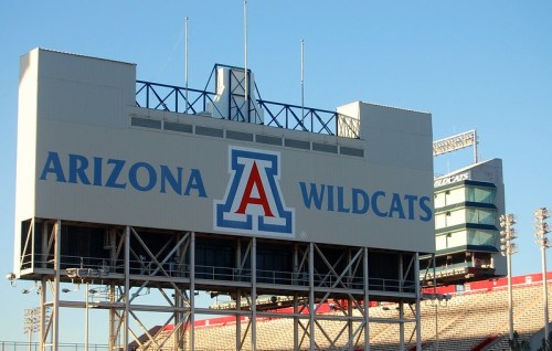 Signage for the Arizona Wildcats at a stadium, featuring the team's logo and name prominently displayed.