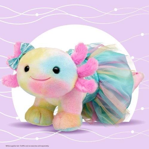 A colorful plush axolotl wearing a tutu and bow, set against a pastel purple background.