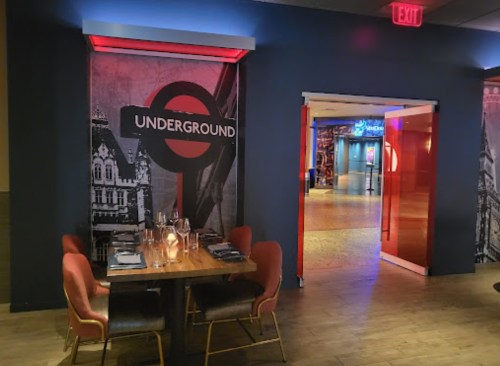 Interior of a restaurant featuring a "Underground" theme, with stylish seating and a vibrant entrance.