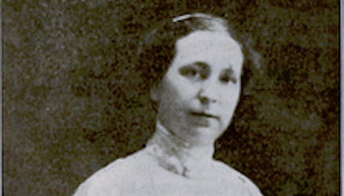 Black and white portrait of a woman with a serious expression, wearing a high-collared dress.
