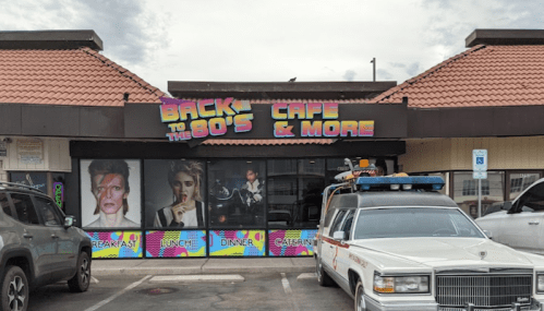 Exterior of "Back to the 80's Cafe & More," featuring colorful signage and retro-themed decor.