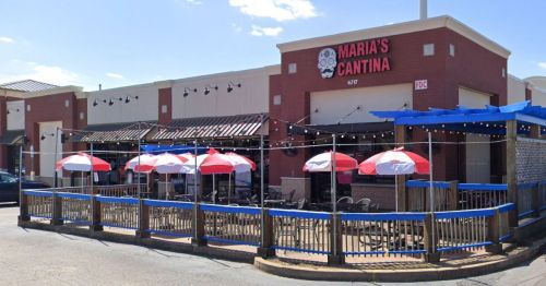 Exterior of Maria's Cantina, featuring a patio with red and white umbrellas and a welcoming entrance.