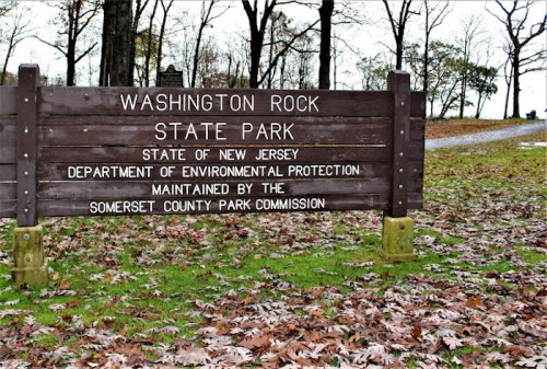 Sign for Washington Rock State Park in New Jersey, maintained by the Somerset County Park Commission, surrounded by fallen leaves.