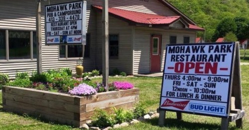 Signage for Mohawk Park Pub & Campground, indicating restaurant hours and open days for lunch and dinner.