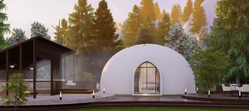 A modern dome-shaped structure surrounded by trees, with a wooden building nearby and a landscaped outdoor area.