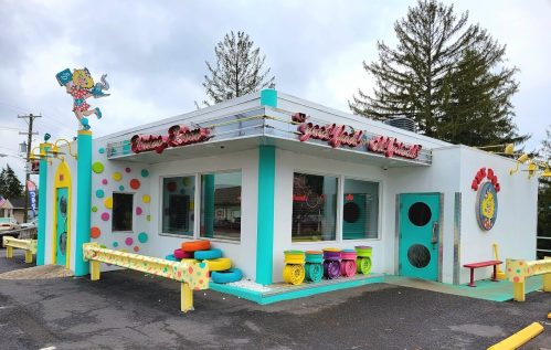 Colorful diner with a playful design, featuring polka dots, bright seating, and a whimsical sign.