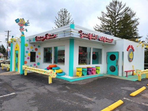Colorful diner with a playful design, featuring polka dots, bright seating, and a whimsical sign.
