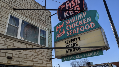Sign for The Fish Keg featuring "Shrimp, Chicken, Seafood" and "Seventy Years Strong" with parking information below.