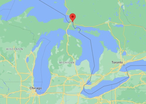 Map showing a location marked with a red pin near the northern tip of Michigan, close to Lake Huron and Ontario.