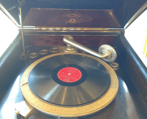 Close-up of a vintage Columbia gramophone with a black vinyl record on the turntable.