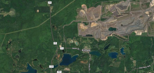 Aerial view of Kinney, Minnesota, showing roads, lakes, and nearby mining operations in a forested area.