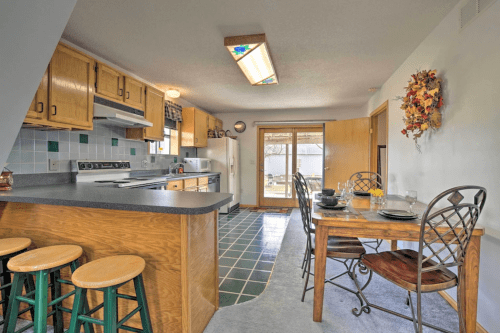 Cozy kitchen with wooden cabinets, a dining table, and sliding glass doors leading to an outdoor area.