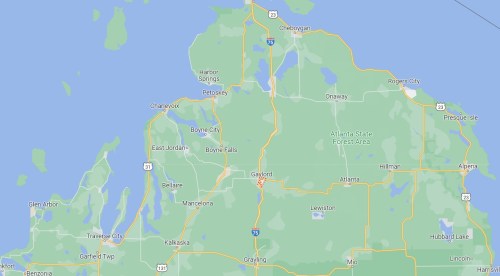 Map of northern Michigan, highlighting towns like Gaylord, Petoskey, and Boyne City, with surrounding lakes and forests.