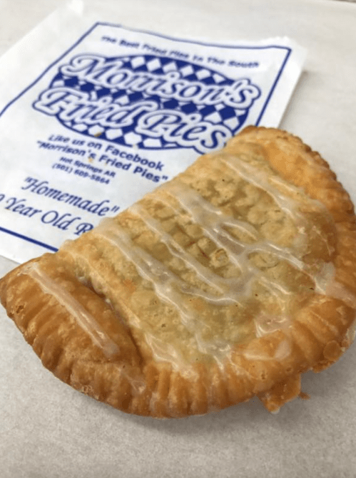 A golden-brown fried pie with a glossy glaze, resting on a paper with the logo of Morrisons Fried Pies.