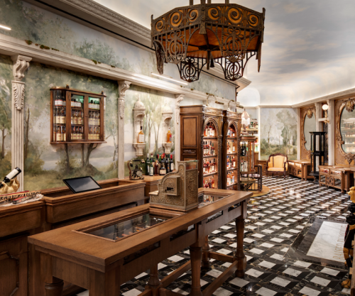 Elegant interior of a vintage-style shop with wooden furniture, a checkered floor, and decorative murals on the walls.