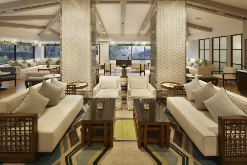 Modern lounge area with stylish furniture, large windows, and decorative accents, creating a cozy and inviting atmosphere.