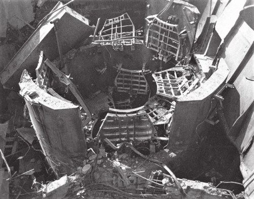 Aerial view of a damaged reactor core, showing debris and structural elements in disarray.