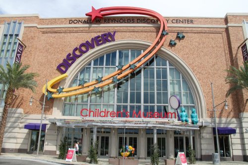 Exterior of the Donal W. Reynolds Discovery Center, featuring colorful signage for the Children's Museum.