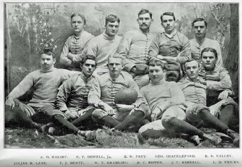 A vintage photo of a football team, featuring eleven players in uniforms, posed together outdoors.