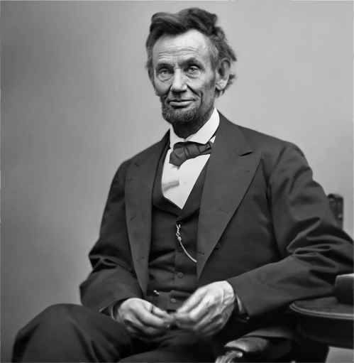 A historical black-and-white portrait of a man with a beard, wearing a suit and bow tie, seated and looking at the camera.