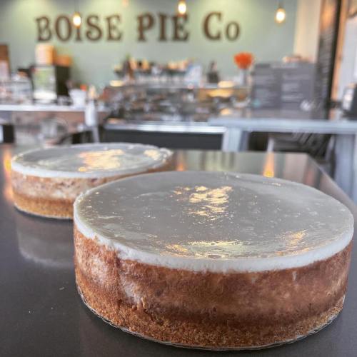 Two uncut pies with a glossy top sit on a counter, with "Boise Pie Co" visible in the background.