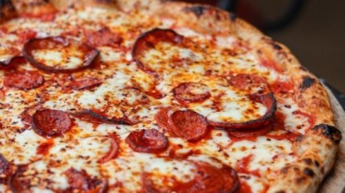 Close-up of a pepperoni pizza with melted cheese and a crispy crust.