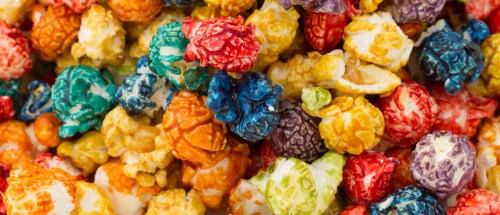A colorful assortment of popcorn in various vibrant hues, including red, blue, green, yellow, and orange.