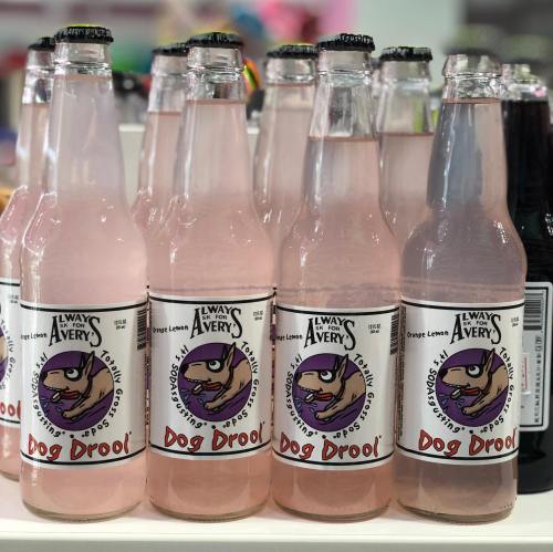 A row of pink soda bottles labeled "Dog Drool" with a cartoon dog on the label.