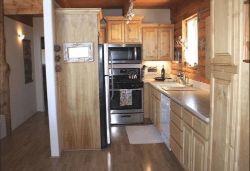Cozy kitchen with wooden cabinets, stainless steel appliances, and a warm, inviting atmosphere.