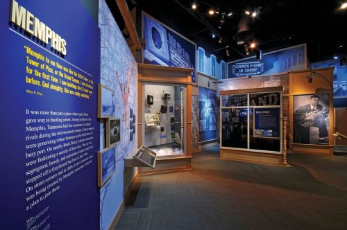 Exhibit showcasing Memphis history with blue walls, text panels, and displays of historical artifacts and photographs.
