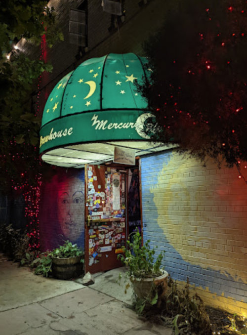 A colorful entrance to a venue called "Mercury," featuring a green dome and vibrant decorations.