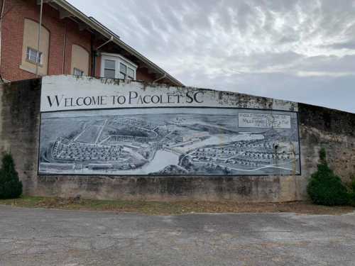 Mural welcoming visitors to Pacolet, SC, featuring a detailed landscape illustration of the area.