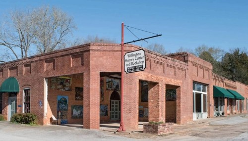 Exterior view of the Wilmington History Center and Bookshop, featuring brick architecture and green awnings.