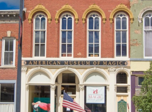 Front view of the American Museum of Magic, featuring large windows and an American flag.