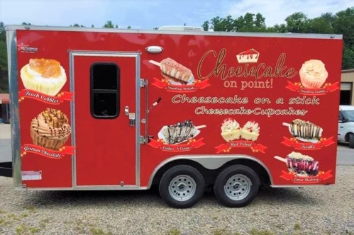 A red food truck with "Cheesecake on Point!" signage, featuring various cheesecake and cupcake images.