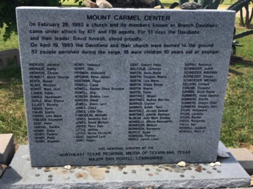 Memorial stone listing names of victims from the Mount Carmel Center siege in 1993, honoring those who perished.
