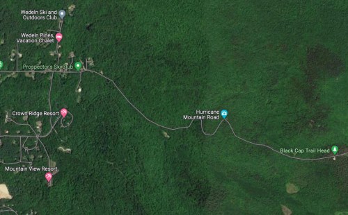 Aerial view of a forested area with roads and nearby resorts, including Crown Ridge and Mountain View, in a mountainous region.